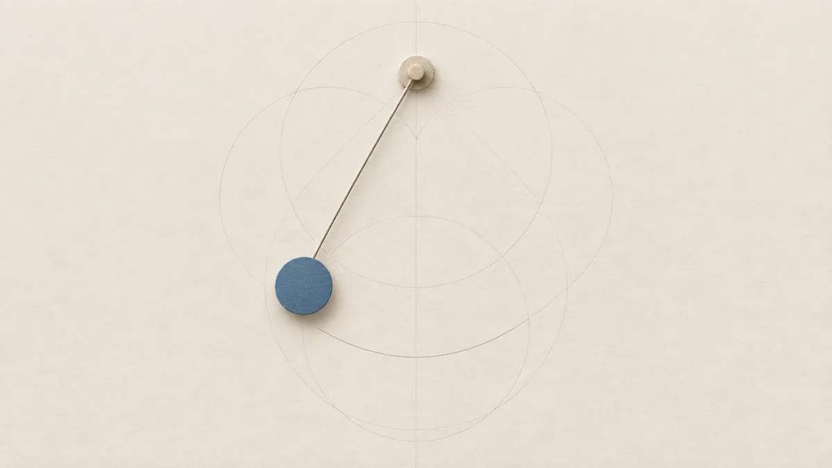 A cut-paper pendulum held at the top of its swing, its round bob blue, on warm off-white paper.