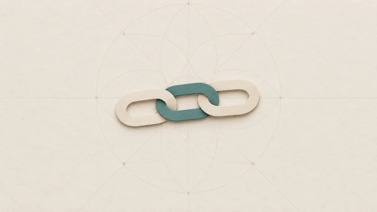 Three interlocked cut-paper chain links in a short row, the middle link teal, on warm off-white paper.