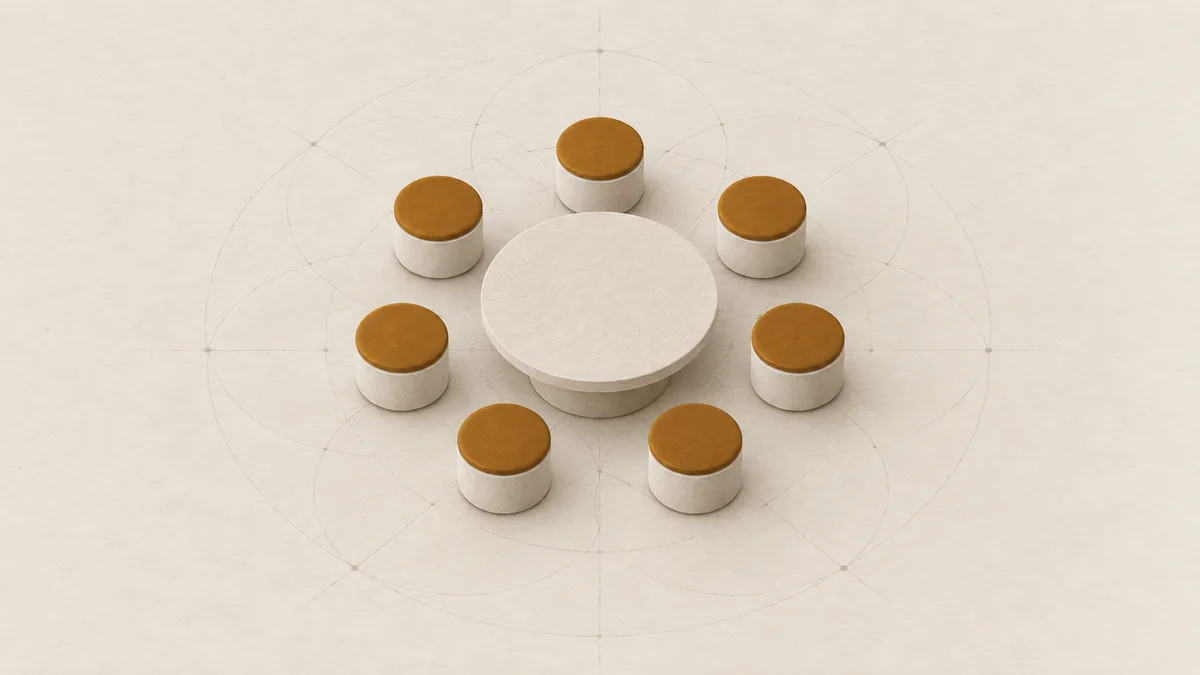 Seven empty stools with amber seats in a ring around a low round table, on warm off-white paper.