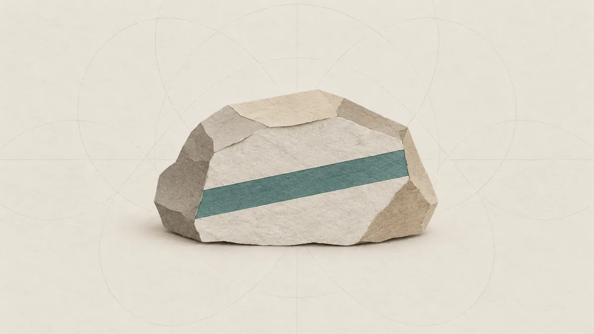 A cut-paper lump of pale angular rock with a teal mineral seam across its broken face, on warm off-white paper.